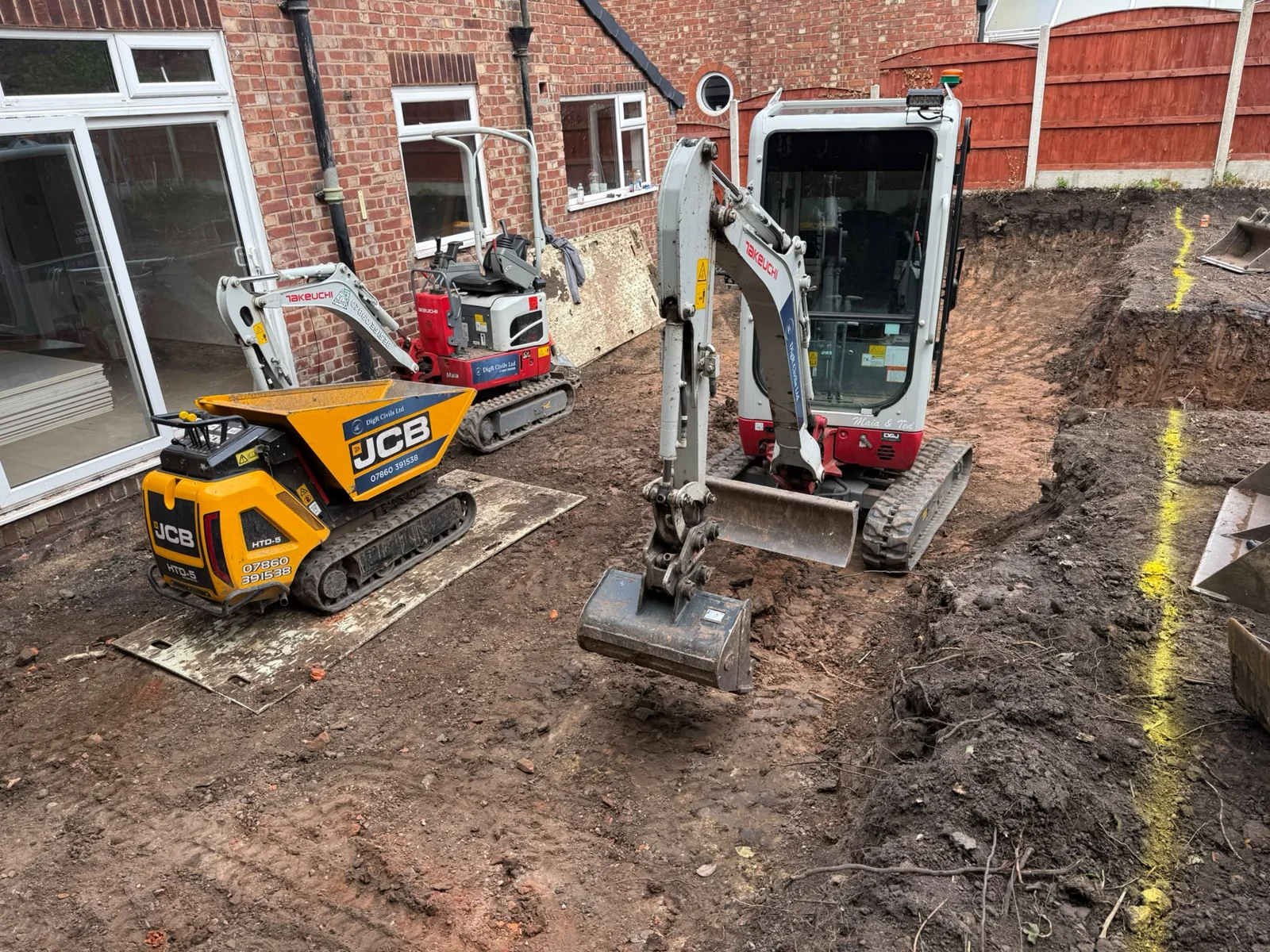DigR Civils mini and micro diggers preparing ground beside a house